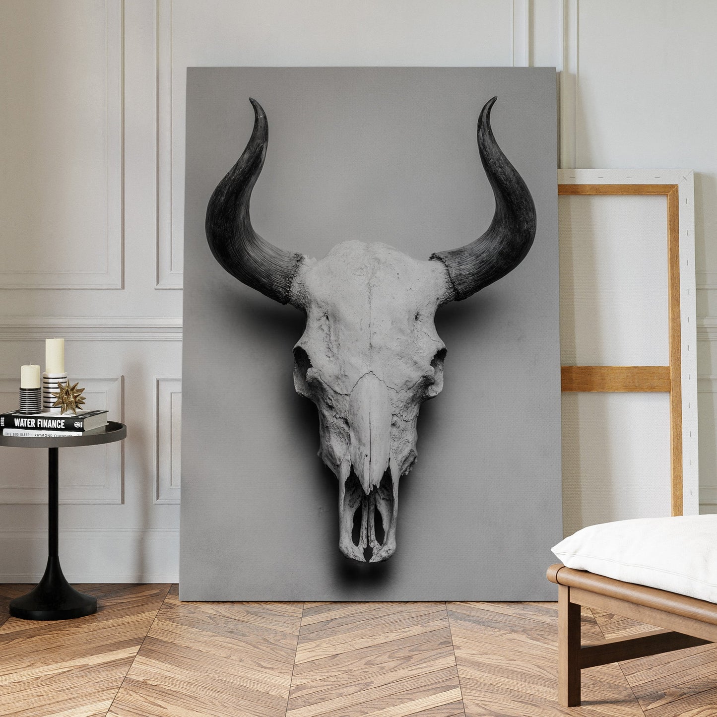 Canvas print of a bull skull in a modern interior setting with a chair and small table.