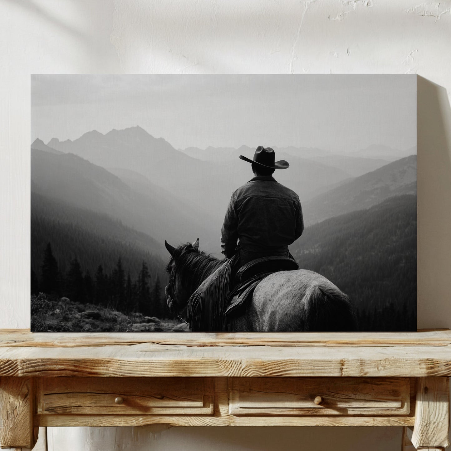 Man on horseback with mountains in the background, displayed on a wooden table.