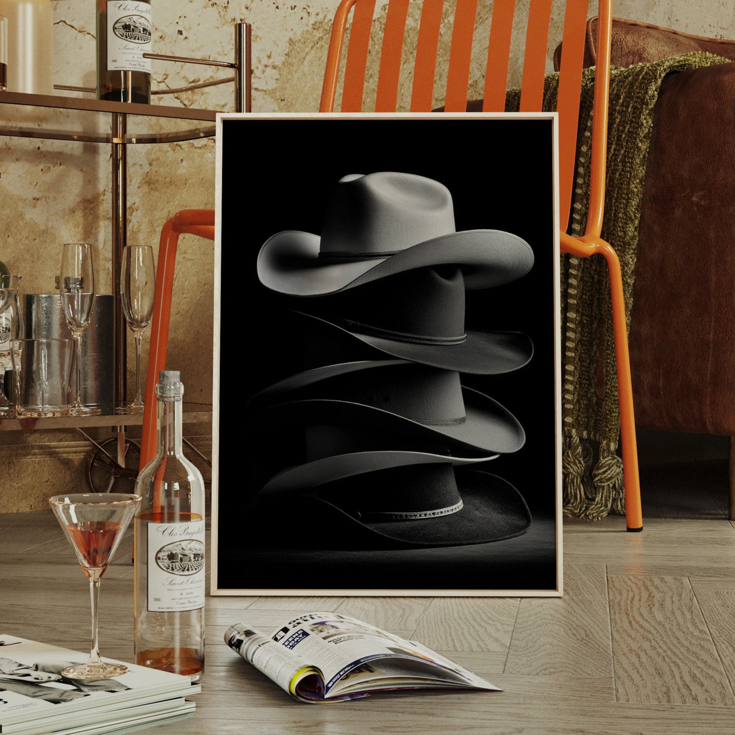 Framed artwork of a hat in a stylish room with a bar and leather chair.