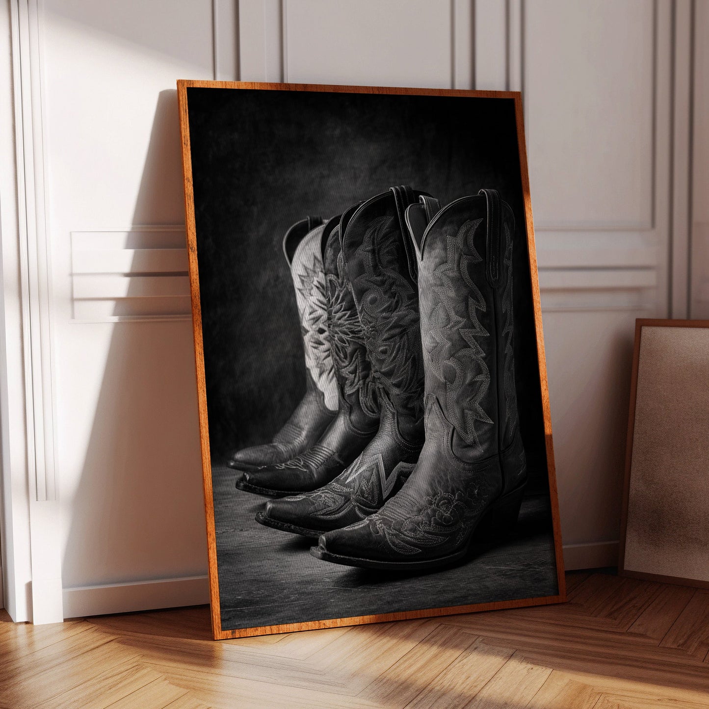 cowboy boots in a row on a framed canvas