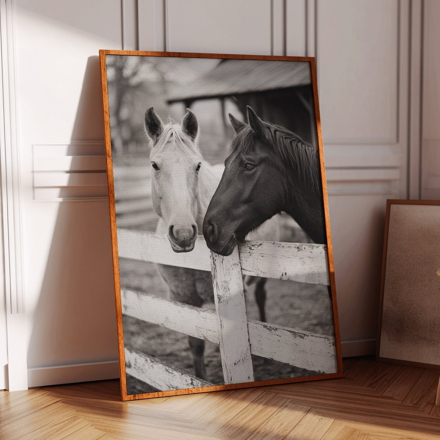 two horses at the ranch fence in black and white