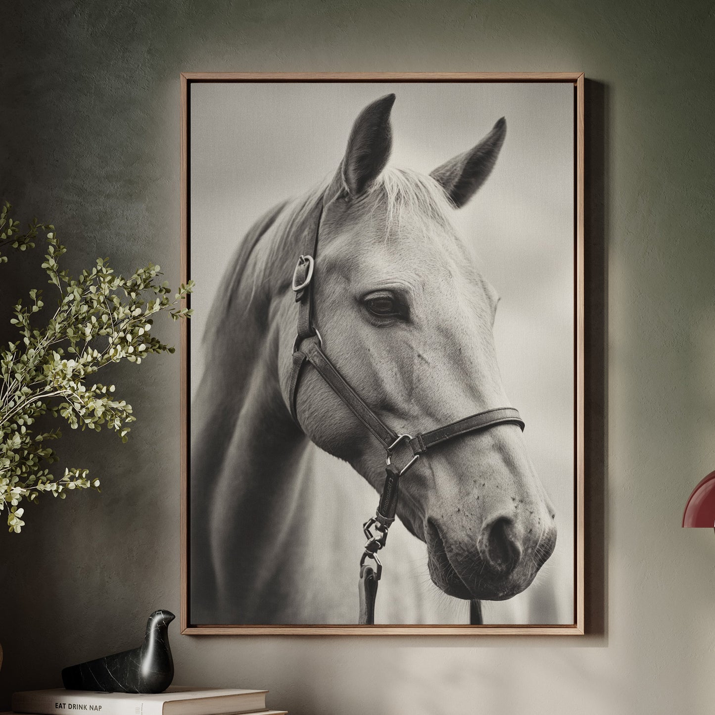 Framed portrait of a horse on a wall above a wooden console table with decor items.