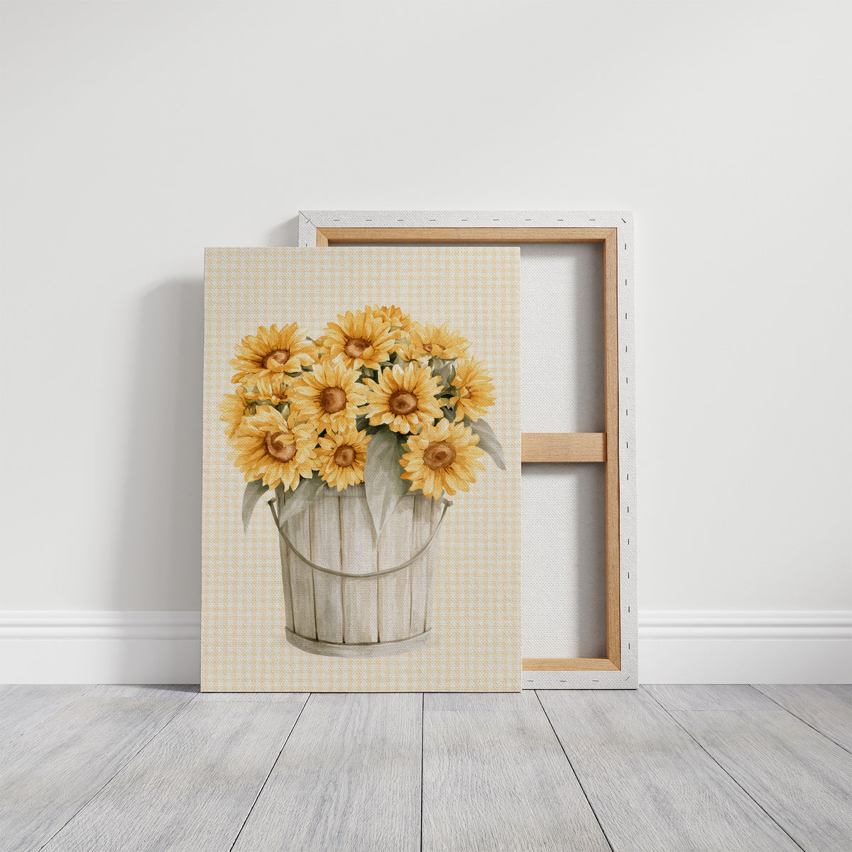 A Bucket of Sunlight Kept Indoors, a bouquet of yellow sunflowers and small blooms in a white metal pail, painted on a fine grid ground in gold, cream and sage, on a gallery canvas with wrapped edges leaning against a white wall