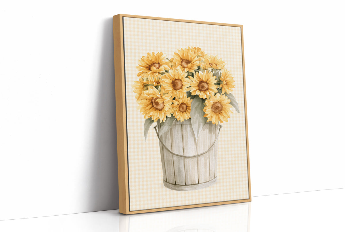 A Bucket of Sunlight Kept Indoors, a bouquet of yellow sunflowers and small blooms in a white metal pail, painted on a fine grid ground in gold, cream and sage, as a framed canvas in a natural wood frame