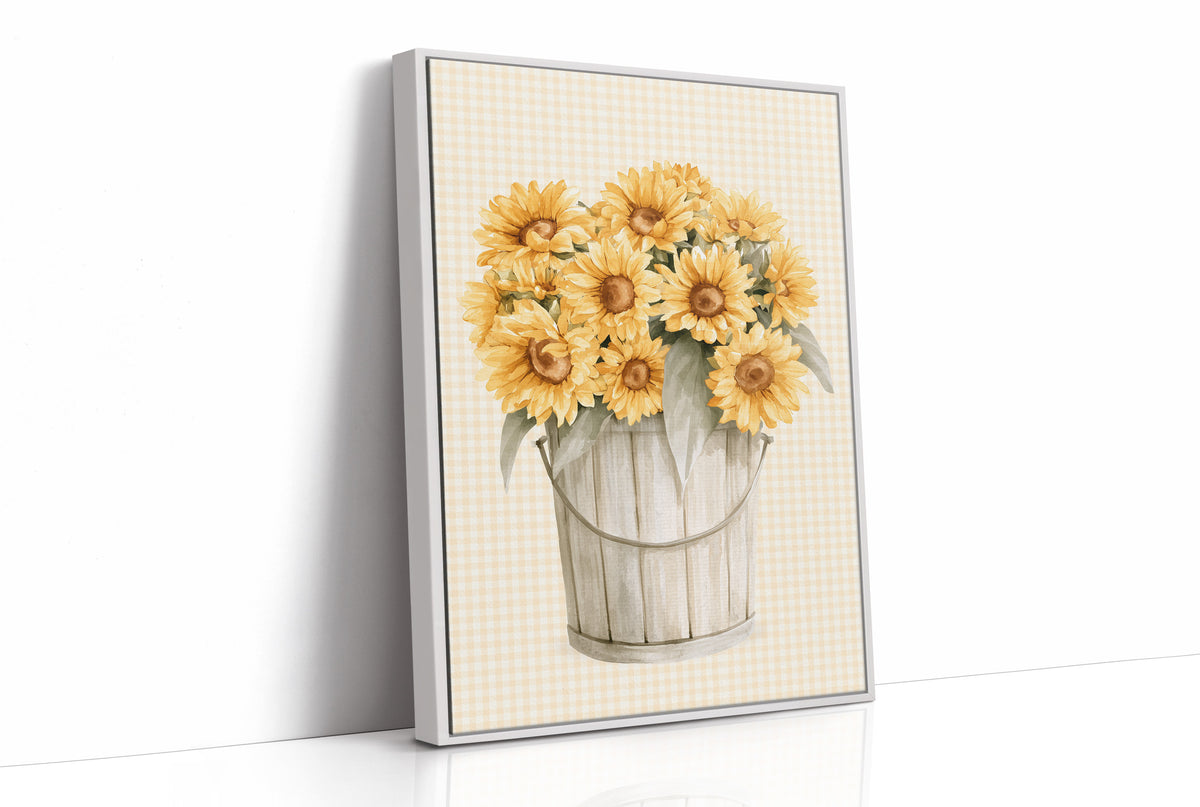 A Bucket of Sunlight Kept Indoors, a bouquet of yellow sunflowers and small blooms in a white metal pail, painted on a fine grid ground in gold, cream and sage, as a framed canvas in a white frame