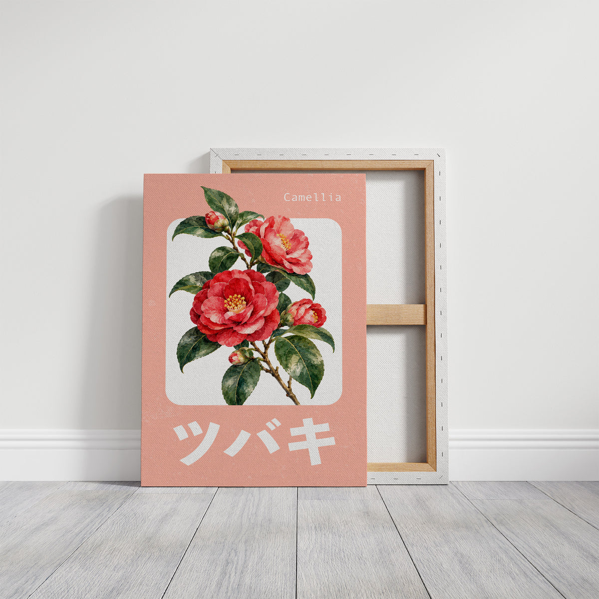 A Camellia Before Noon, a red camellia bloom with green leaves on a blush pink ground, with a rounded cream label and bold pale Japanese lettering, in a flat Japanese travel poster style painted in red, blush pink and cream, on a gallery canvas with wrapped edges leaning against a white wall