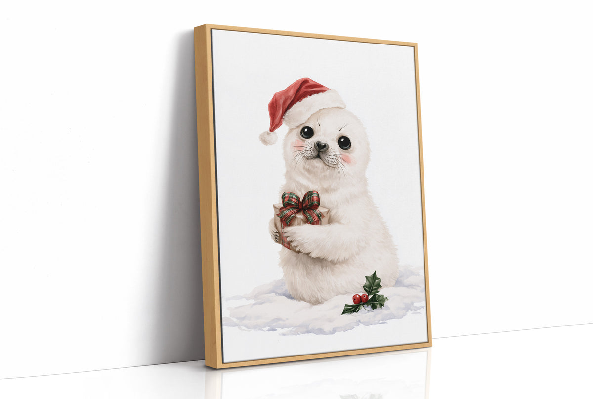 A Snowy Pup Waits for Morning, a white baby seal in a red Santa hat holding a chocolate bow, with a sprig of holly in the snow below, painted in soft cream, red and white, as a framed canvas in a natural wood frame