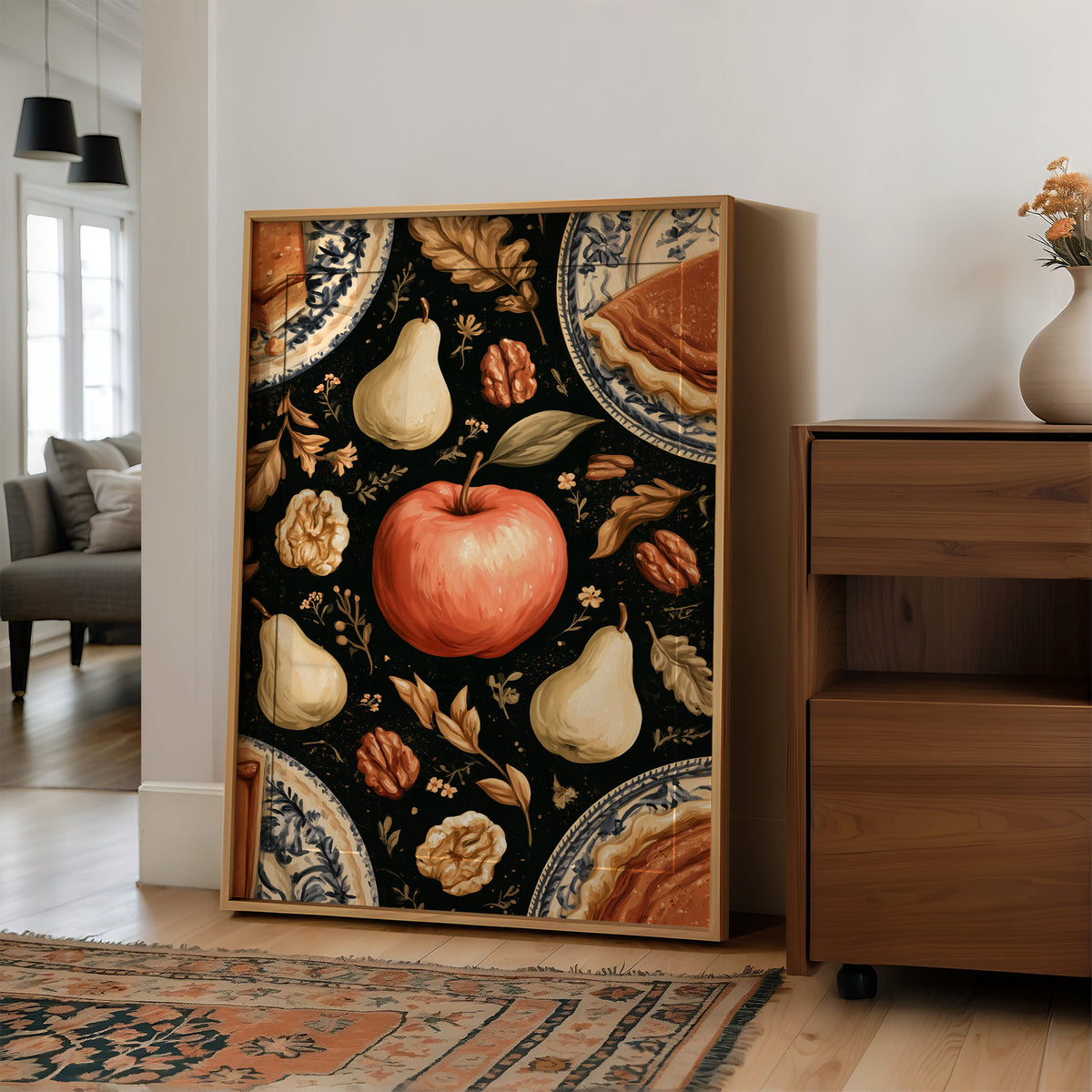 A Table Laid Before Dusk, a dark still life pattern of red apples, pale pears, walnuts and autumn leaves around pie plates, painted in charcoal, cream and rust, in a wood frame on a wall beside a walnut cabinet and an open doorway
