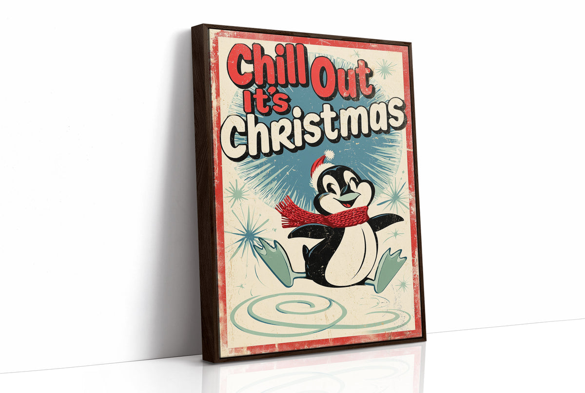 Chill Out, Cold Is Cozy, a vintage style penguin in a red scarf and a Santa hat sitting on a snowy patch, with a retro sign line of bold lettering above him, in red, cream and soft teal, as a framed canvas in a brown frame
