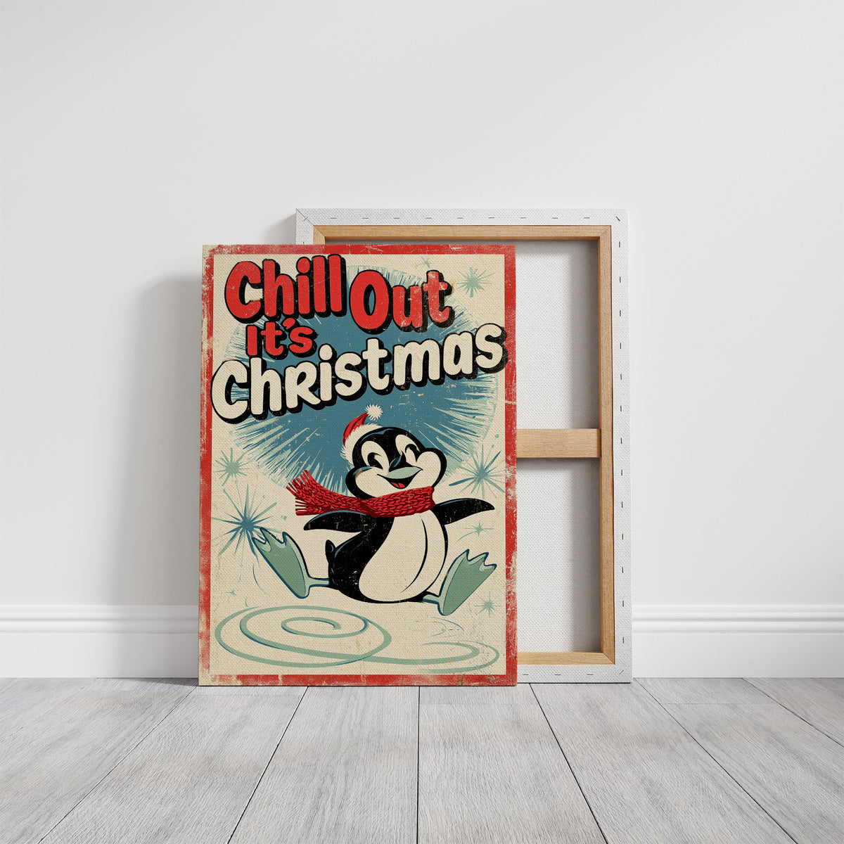 Chill Out, Cold Is Cozy, a vintage style penguin in a red scarf and a Santa hat sitting on a snowy patch, with a retro sign line of bold lettering above him, in red, cream and soft teal, on a gallery canvas with wrapped edges leaning against a white wall