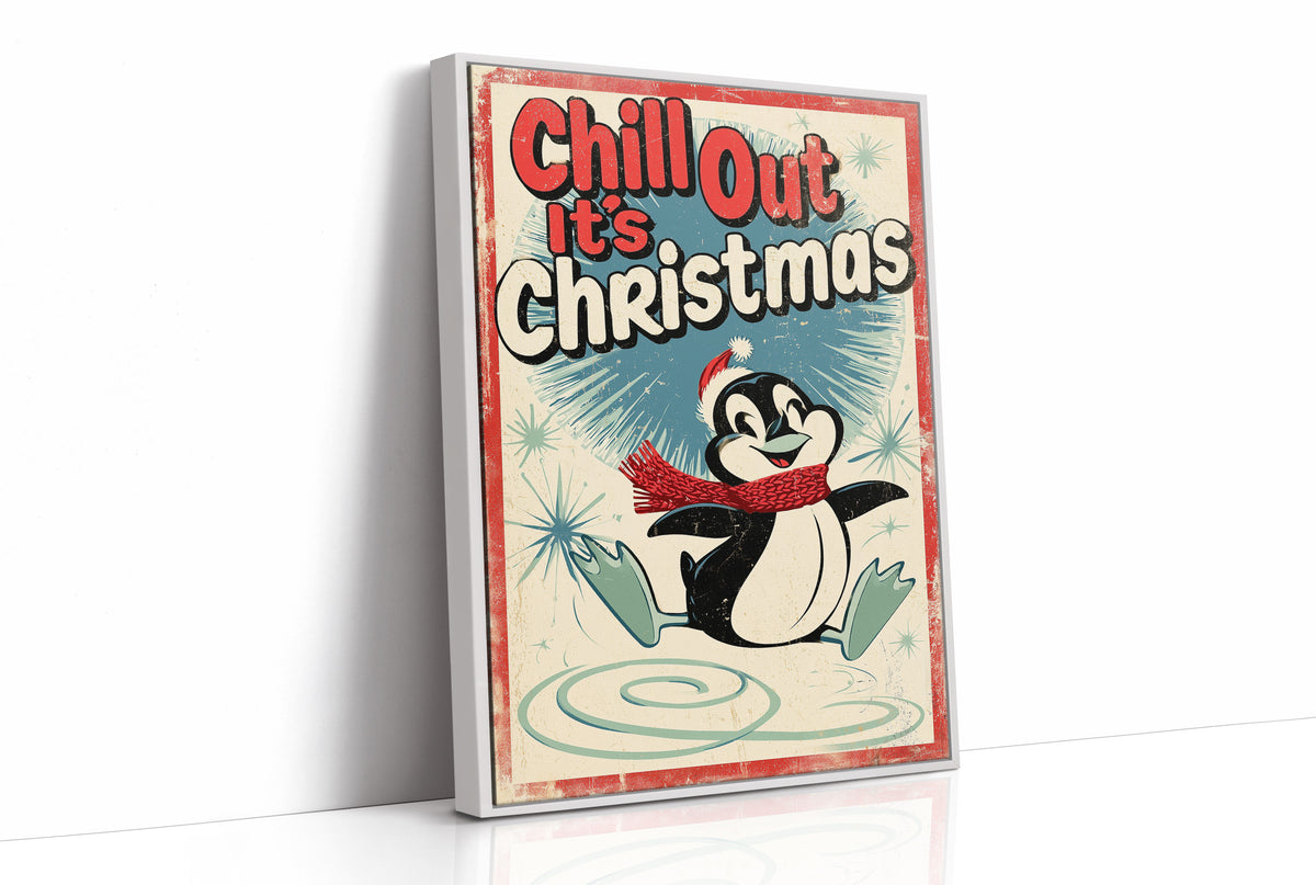 Chill Out, Cold Is Cozy, a vintage style penguin in a red scarf and a Santa hat sitting on a snowy patch, with a retro sign line of bold lettering above him, in red, cream and soft teal, as a framed canvas in a white frame