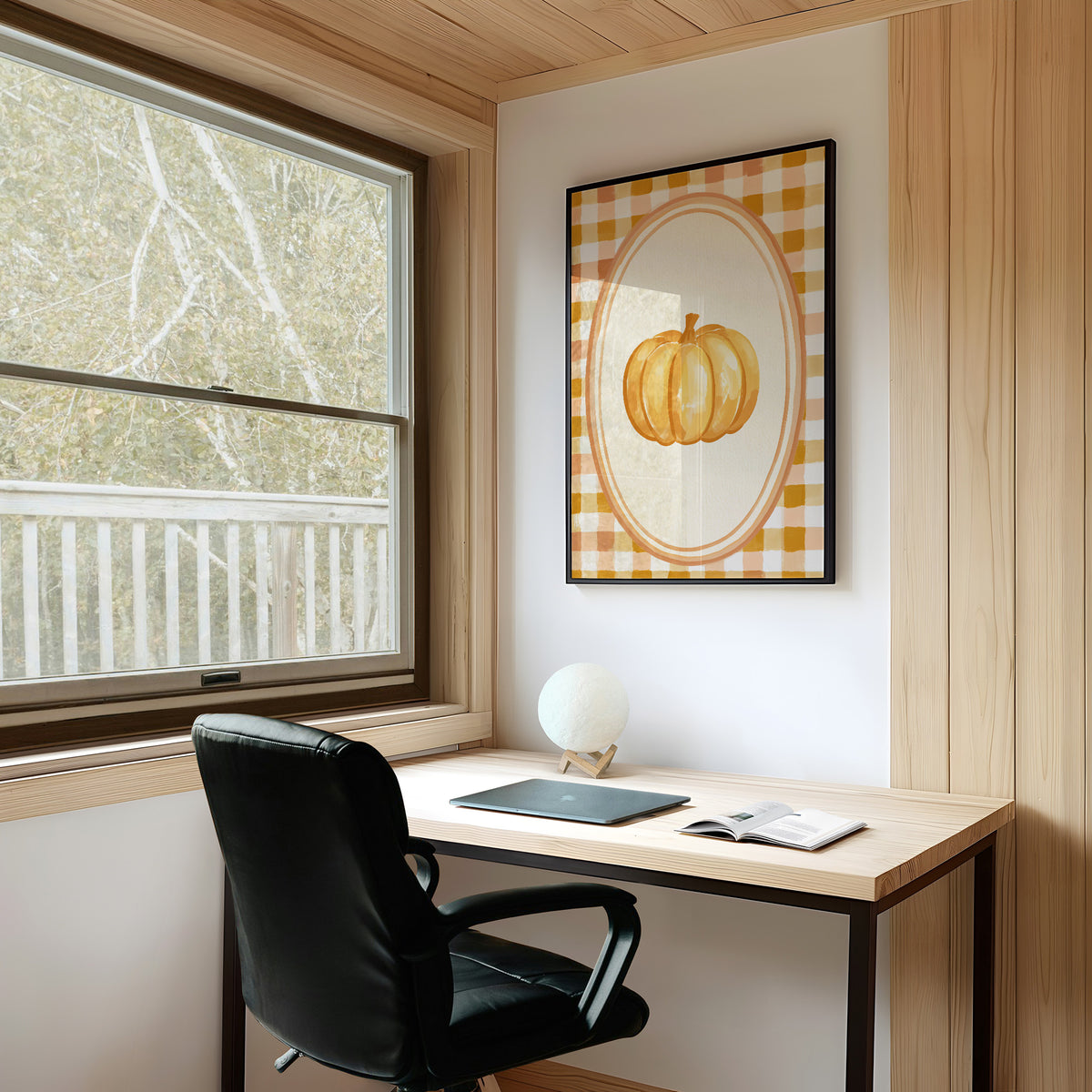 Dressed Up for a Quiet Afternoon, a single orange pumpkin in a cream oval medallion framed by a yellow and rust gingham border, painted in mustard, cream and burnt orange, on a study wall above a writing desk and a black desk chair