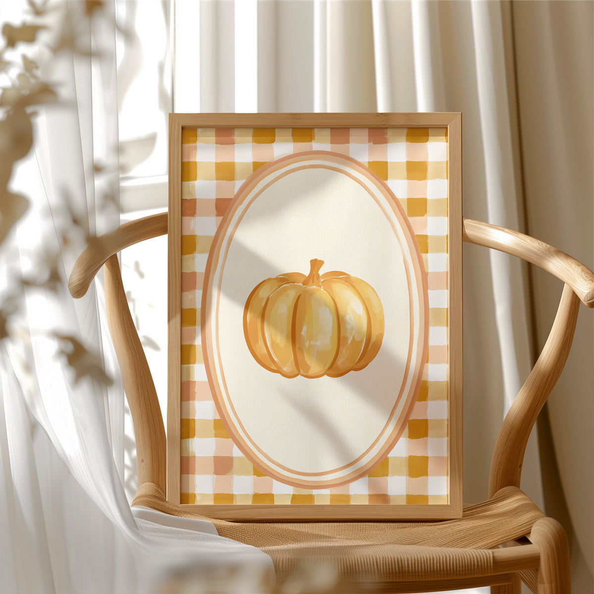 Dressed Up for a Quiet Afternoon, a single orange pumpkin in a cream oval medallion framed by a yellow and rust gingham border, painted in mustard, cream and burnt orange, in a wood frame beside a wicker chair by a sunny window