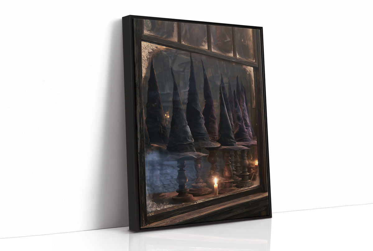 Fitted for Midnight Flights, row of dark witch hats on wooden stands in a frosted shop window with a candle, as a framed canvas in a black frame