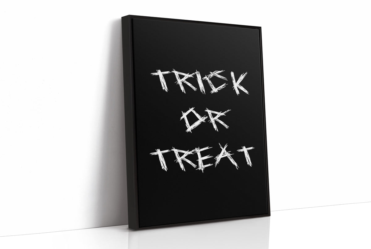 Knock Once for the Sweets, bold chalky white lettering reading TRICK OR TREAT on a solid black ground, hand lettered with a worn brush texture, as a framed canvas in a black frame