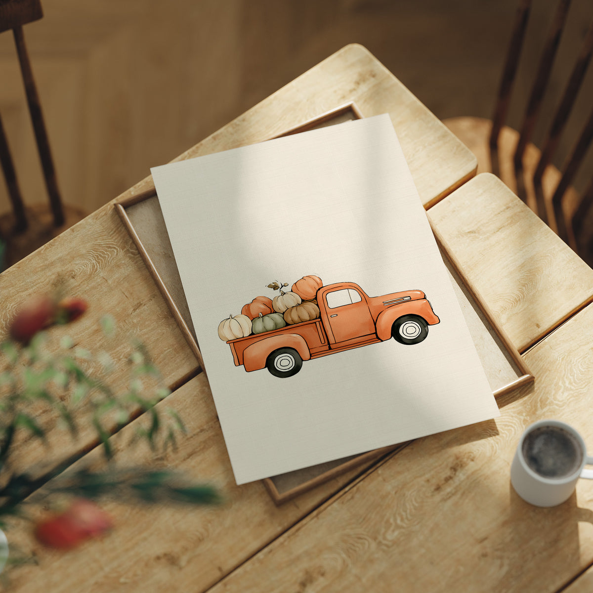 Last Load Up the Orchard Road, a small orange vintage pickup truck loaded with pumpkins and gourds on a cream ground, painted in soft watercolor, lying flat on a light wood table beside a coffee cup and red berries