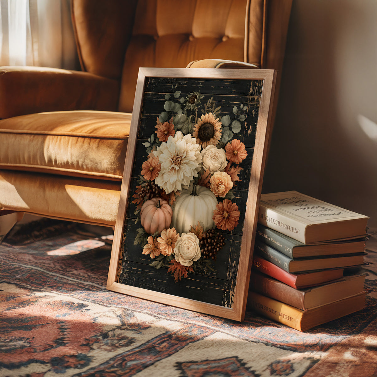 Late Blooms Remember the Harvest, a dark floral bouquet of dahlias, cream roses and small pumpkins with eucalyptus, painted in cream, rust and burnt orange on a black ground, in a wood frame on a rug beside a leather armchair and a stack of books