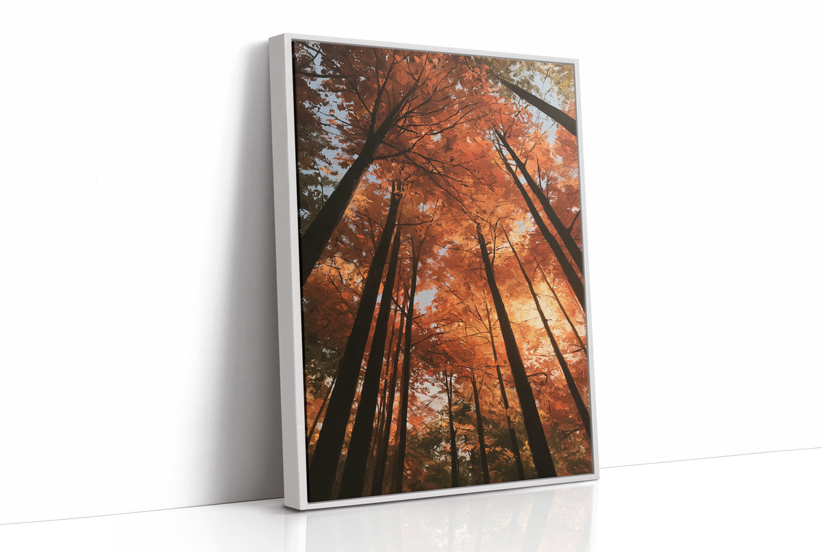 Look Up Into the Burning Wood, looking straight up through a canopy of tall dark trunks and orange autumn foliage, the pale sky glowing behind them, painted in rust, burnt orange and charcoal, as a framed canvas in a white frame