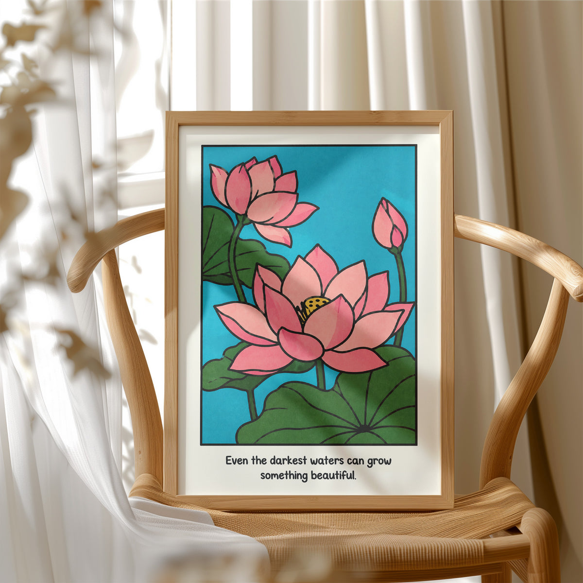 Lotus Rising From Dark Water, a pink lotus flower with a bud and large green leaves on a bright teal pond, with the quote Even the darkest waters can grow something beautiful in small black lettering along the bottom, in a wood frame beside a wicker chair by a sunny window