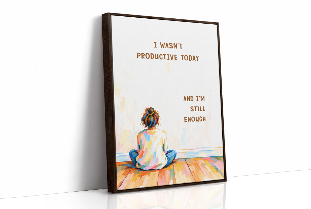 Quiet Hours on Painted Floors, a child seen from behind sitting cross legged on painted floorboards in coral, blue and cream, with two lines of bold brown lettering on a pale cream ground, in a soft illustrated style, as a framed canvas in a brown frame