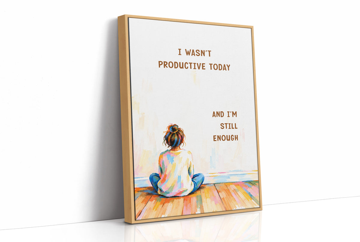 Quiet Hours on Painted Floors, a child seen from behind sitting cross legged on painted floorboards in coral, blue and cream, with two lines of bold brown lettering on a pale cream ground, in a soft illustrated style, as a framed canvas in a natural wood frame