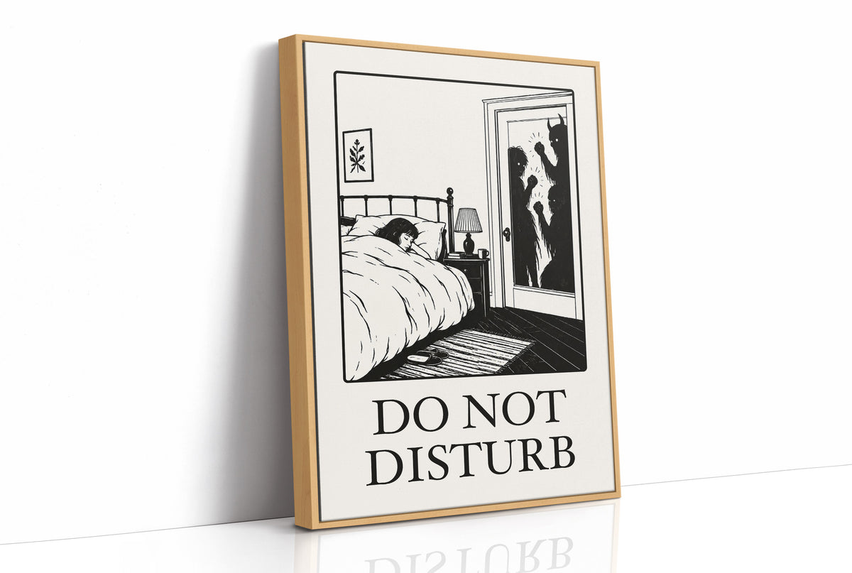 Quiet Hours Until Someone Knocks, a black ink woodcut style scene of a woman asleep in bed beside a lamp and a small framed plant picture while horned shadows lurk at the open door, and the words DO NOT DISTURB in black serif capitals on cream paper, as a framed canvas in a natural wood frame