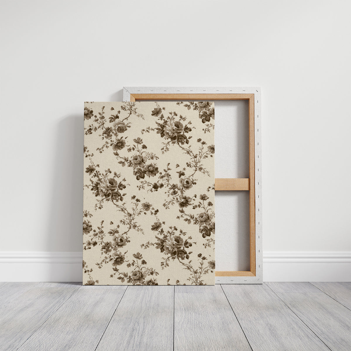 Roses Keep to the Linen, a repeating vintage pattern of brown roses and leafy sprigs on a cream ground, on a gallery canvas with wrapped edges leaning against a white wall