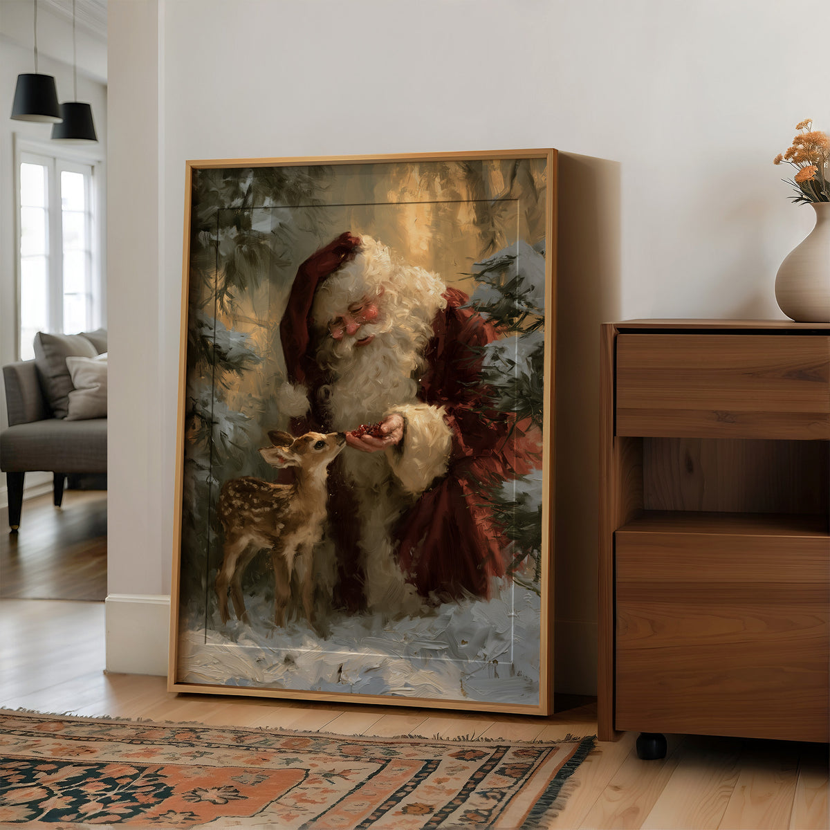 Saint Nick Keeps a Fawn Close, a painterly vintage Santa Claus in a red hat with a fawn tucked against his coat, set among pine boughs in snow, painted in deep green, rust and gold, in a wood frame on a wall beside a walnut cabinet and an open doorway