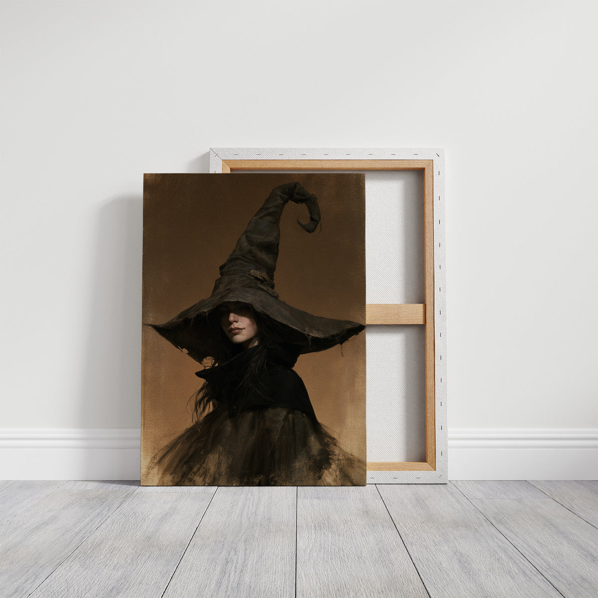 She Keeps Her Own Counsel, a dark witch in a tall pointed hat and a cloak, in a sepia portrait with a gilt frame, on a gallery canvas with wrapped edges leaning against a white wall