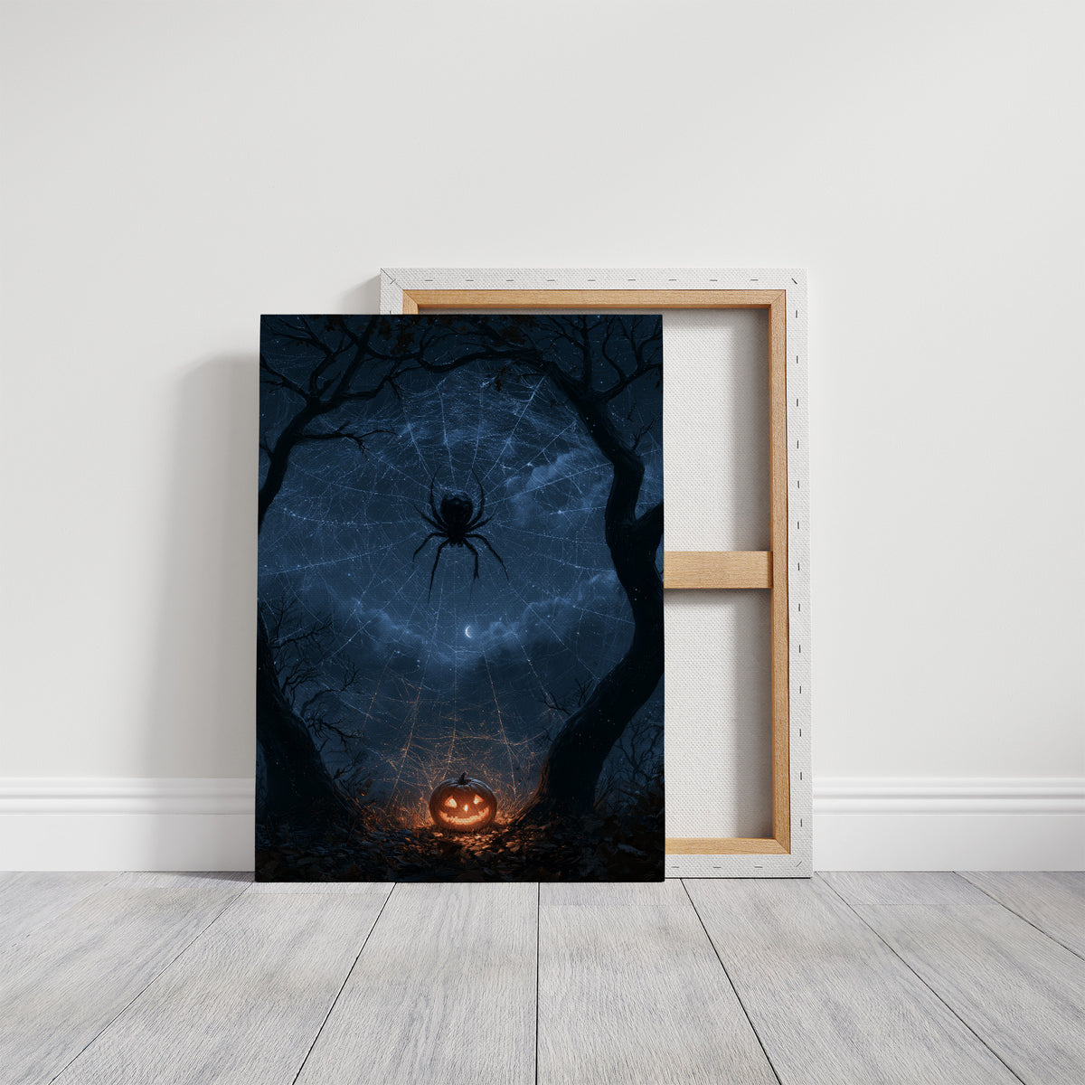 Silver Threads Over the Hollow, spider web glowing with silver threads over a blue night forest with a pumpkin lantern painting, on a gallery canvas with wrapped edges leaning against a white wall