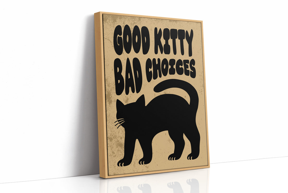 Sleek Silhouette, Questionable Taste, a solid black cat silhouette with a long tail curled up the side, standing on tan paper with the words GOOD KITTY BAD CHOICES in bold black lettering, as a framed canvas in a natural wood frame