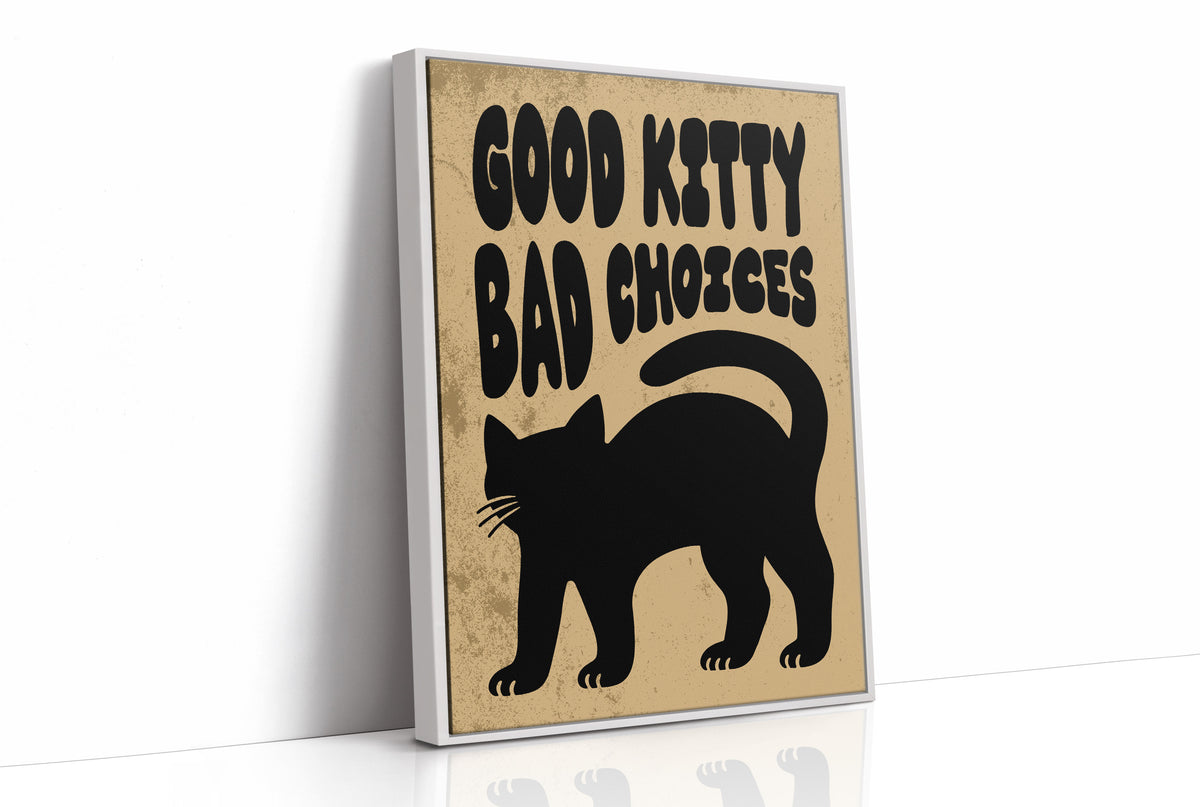 Sleek Silhouette, Questionable Taste, a solid black cat silhouette with a long tail curled up the side, standing on tan paper with the words GOOD KITTY BAD CHOICES in bold black lettering, as a framed canvas in a white frame