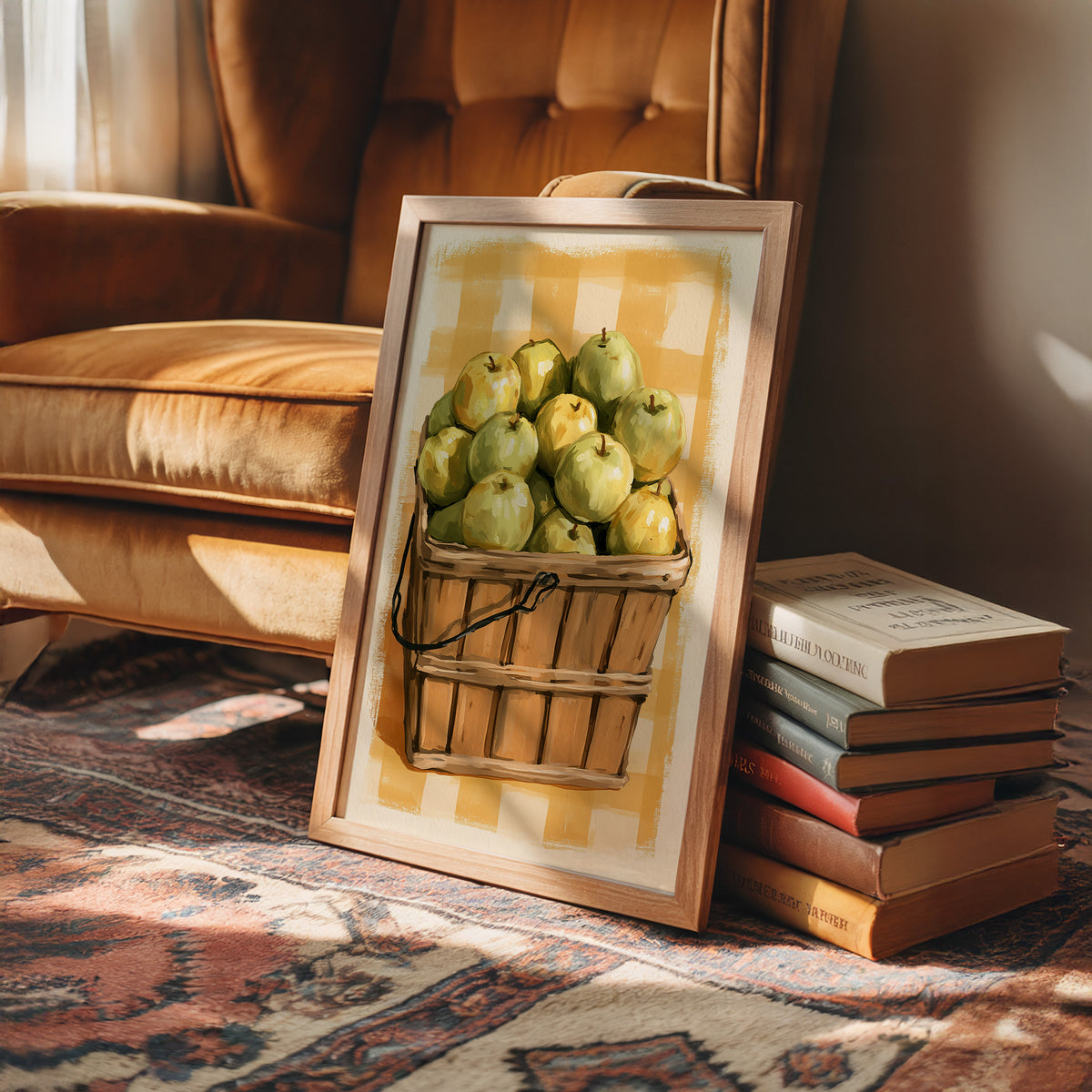 Something Sweet Waits in the Basket, a basket heaped with pale green pears on a soft yellow gingham ground, painted in lemon, sage and warm tan, in a wood frame on a rug beside a leather armchair and a stack of books