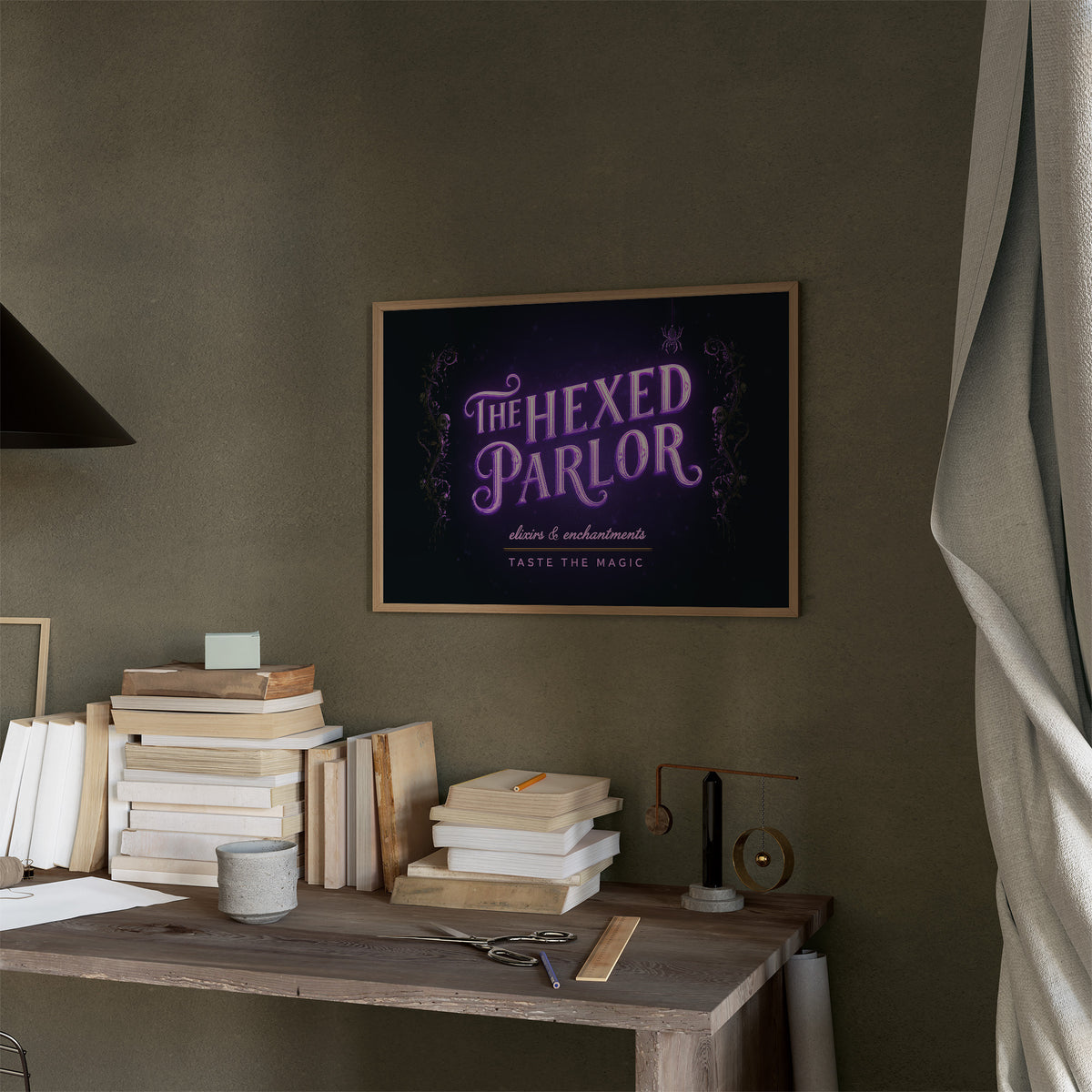 Taste the Magic Tonight, violet neon sign reading the hexed parlor on a black painting, in a thin wood frame on a moss green wall above a desk stacked with books