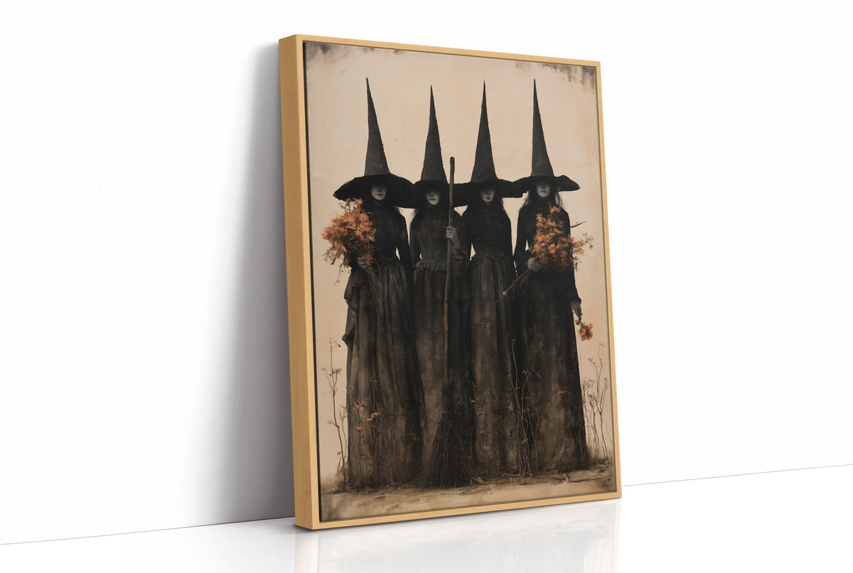 The Coven Keeps Its Silence, five witches in tall pointed hats standing shoulder to shoulder, painted in black, charcoal and dusty cream, as a framed canvas in a natural wood frame