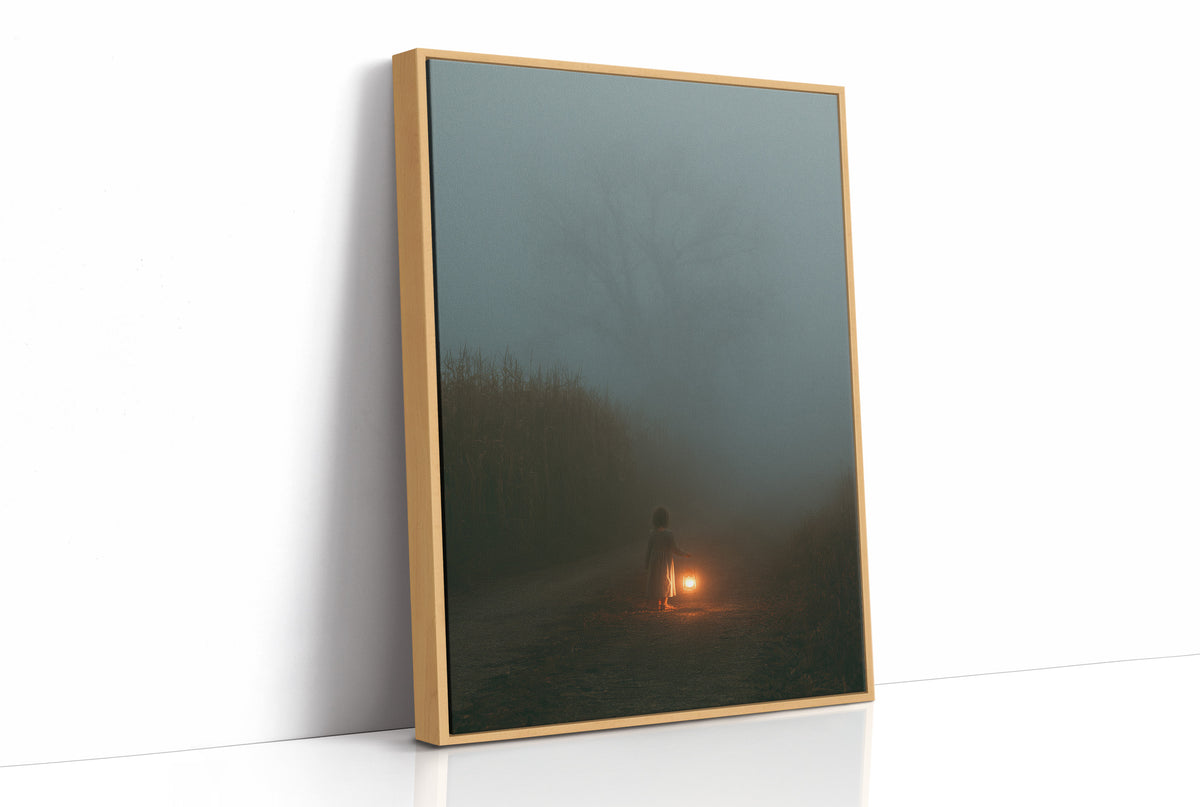 The Ember Keeps Watch in the Mist, a tiny warm light glowing at the foot of a hazy green field in dark fog, painted in deep spruce, slate green and a single amber glow, as a framed canvas in a natural wood frame