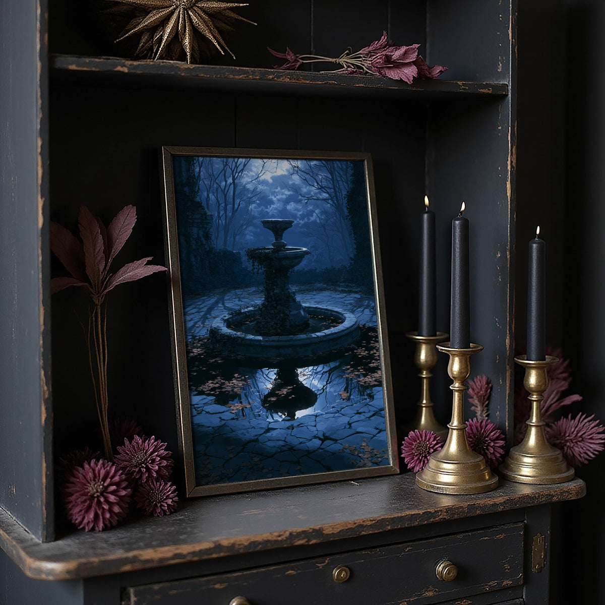 The Fountain Holds Its Breath, moonlit garden fountain painting in deep blue, on a dark wooden cabinet shelf with candles and dried flowers