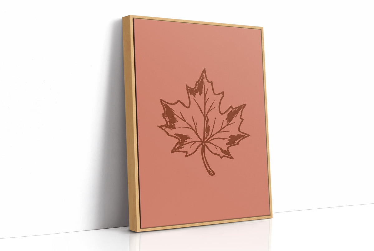 The Maple Keeps Its Last Light, a single maple leaf drawn in fine brown outline on a dusty terracotta ground, a botanical line study with soft shading, as a framed canvas in a natural wood frame