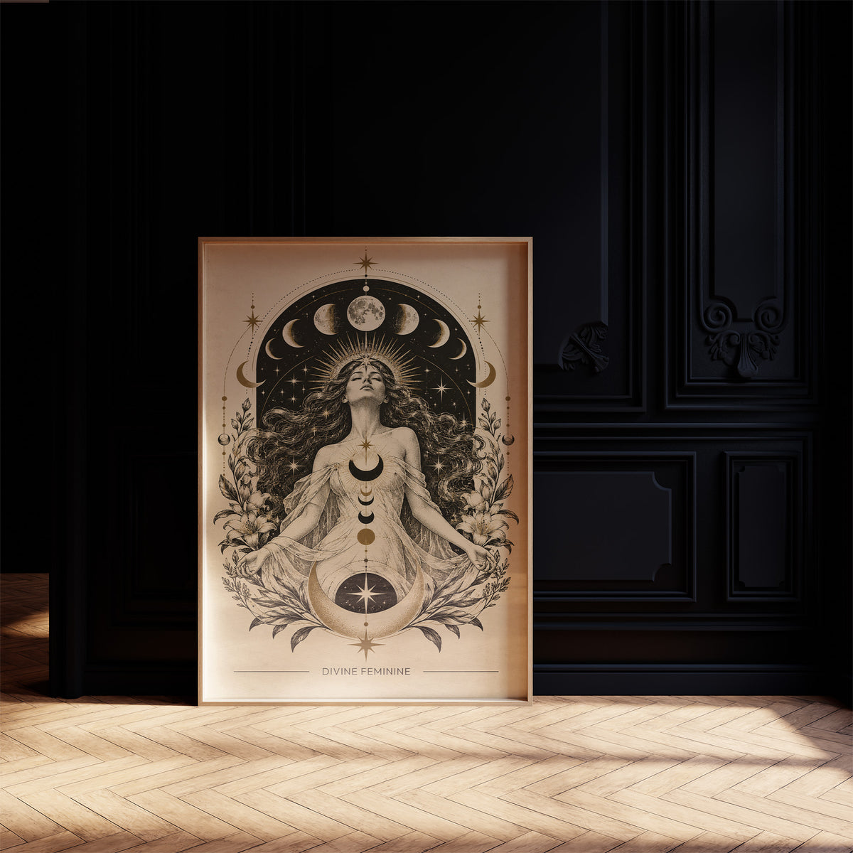 The Moon Woven Into Her Hair, a seated woman in quiet meditation crowned with a ring of crescent moons and surrounded by fern fronds, drawn in cream, charcoal and sepia with a deep brown border and small text at the base, in a dark frame on a black paneled wall above a sunlit herringbone floor