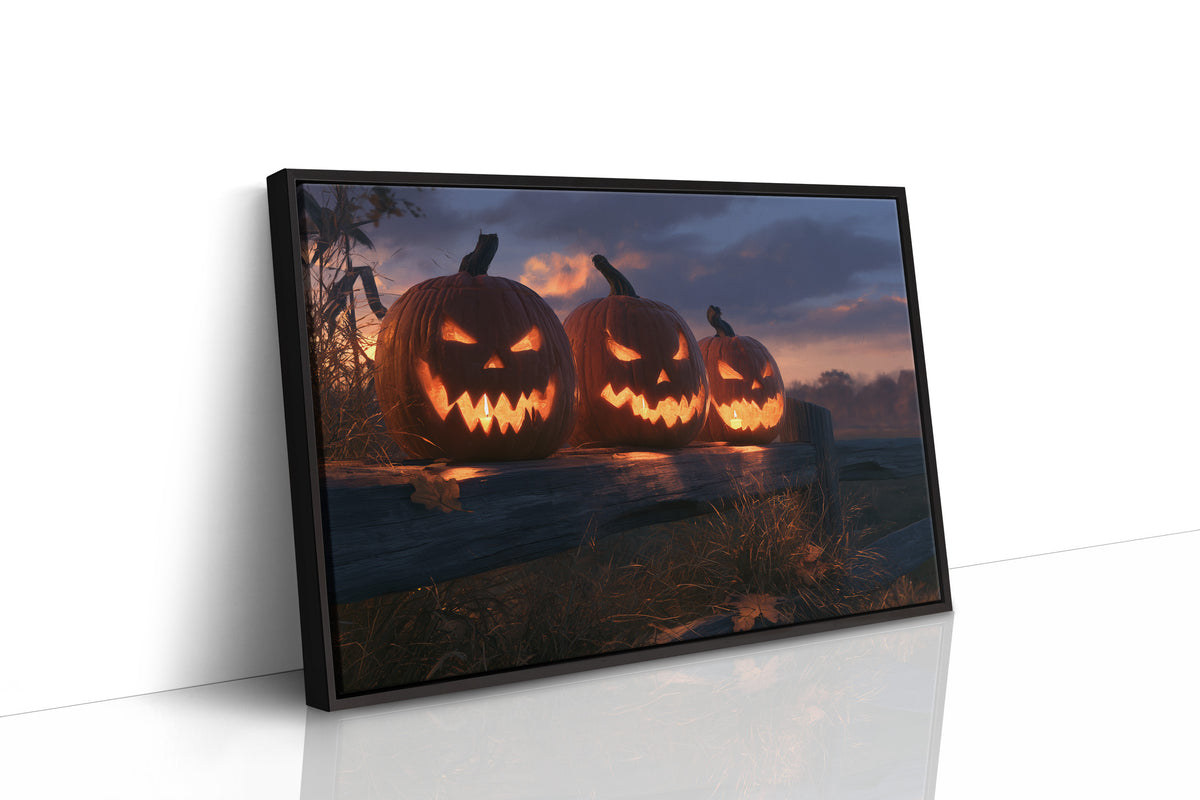 Three Faces Wait Up for You, three carved jack o lantern pumpkins glowing on a dusky field at twilight painting, as a framed canvas in a black frame