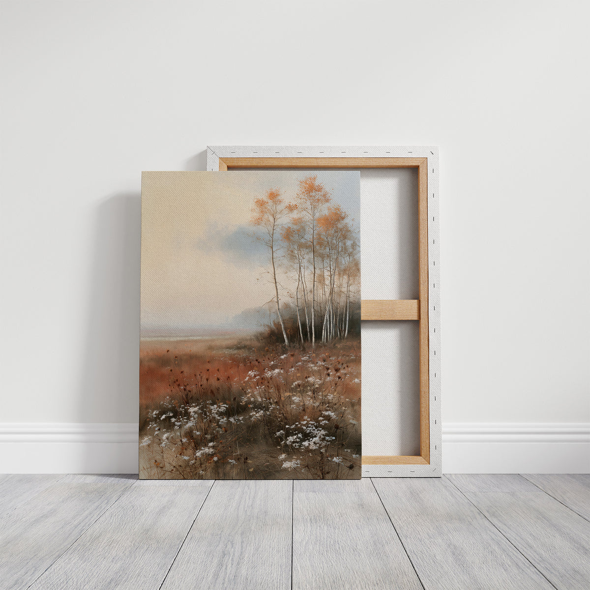 Where the Birches Lean Toward Dusk, a stand of pale birch trees with a few amber leaves in a misty meadow of rust grass and wildflowers under a soft blue sky, painted in dusty blue, rust and cream, on a gallery canvas with wrapped edges leaning against a white wall