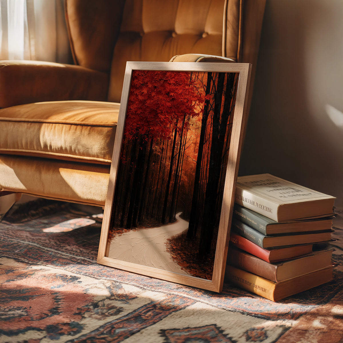 Where the Crimson Path Bends, a winding forest path through tall dark trunks under a blaze of red canopy, painted in deep crimson, russet and warm shadow, in a wood frame on a rug beside a leather armchair and a stack of books