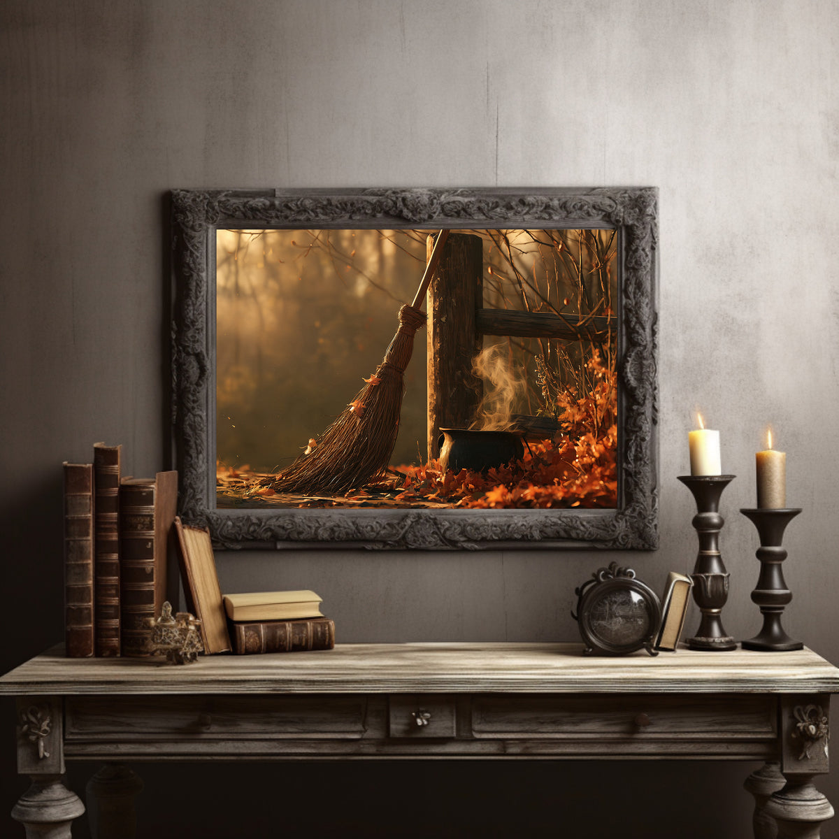 Where the Leaves Lie Down, a wooded path of fallen leaves in amber and rust under soft morning light, in a dark carved frame on a gray wall above a console table with candlesticks and old books