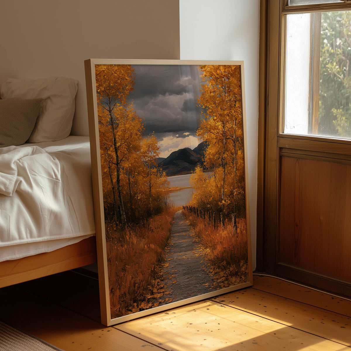 Where the Storm Lets Go of the Lane, a dirt lane between gold birches toward soft mountains under a clearing gray sky, painted in amber, slate and rust, leaning on a wood floor in a bedroom beside white linen bedding