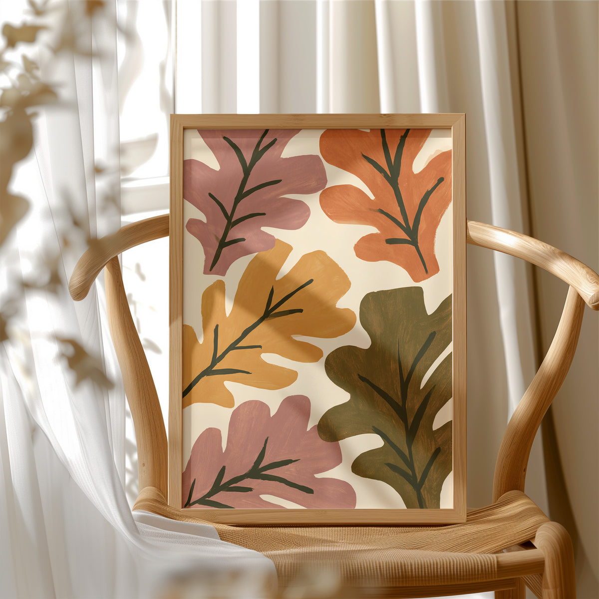 Big Leaf Energy, framed print resting on a wooden chair beside sheer curtains