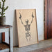 Skeletal design on a wooden board leaning against a wall with a plant and rustic furniture.