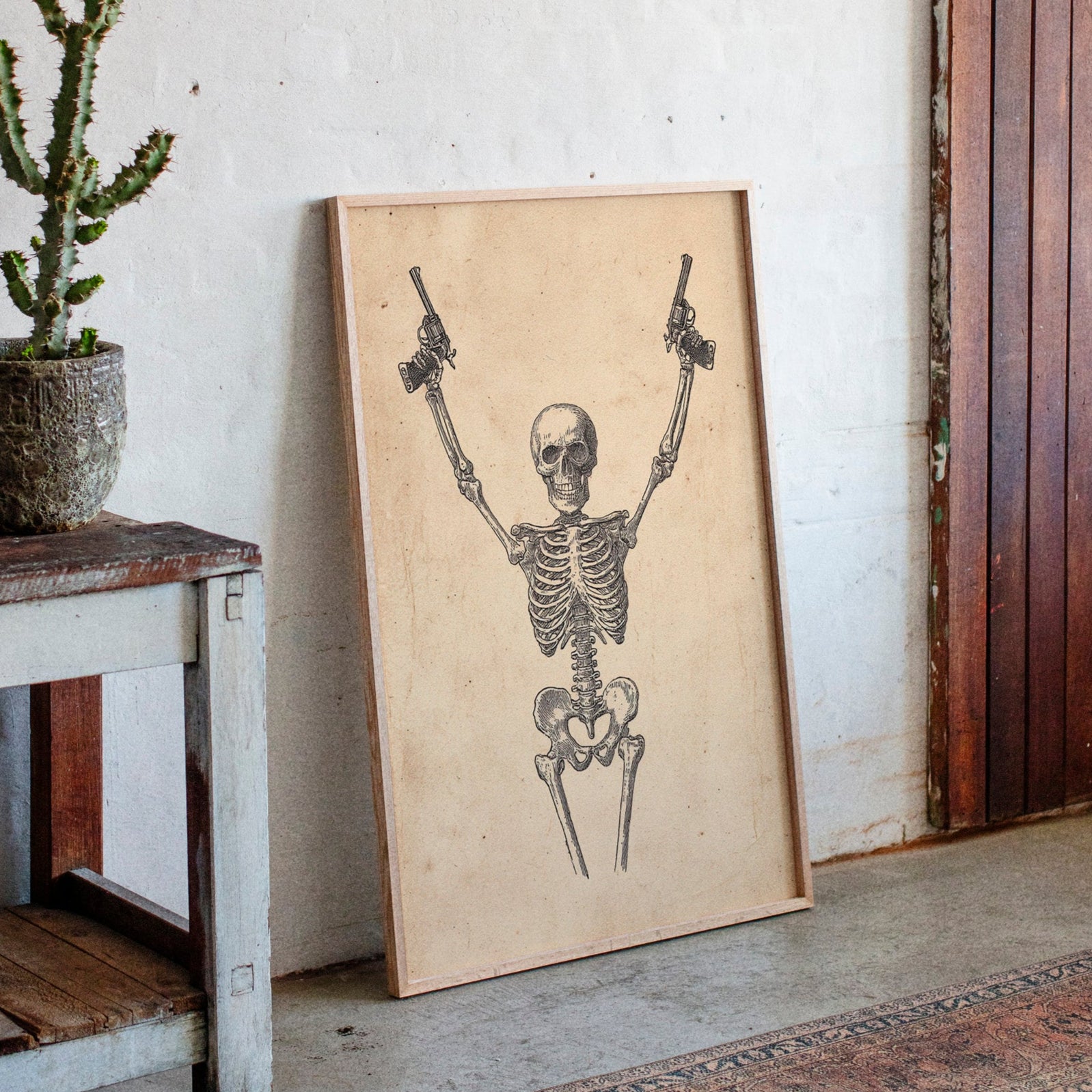 Skeletal design on a wooden board leaning against a wall with a plant and rustic furniture.