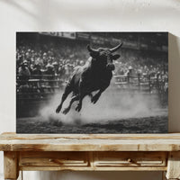 Black and white photo of a bull in mid-air over a wooden table