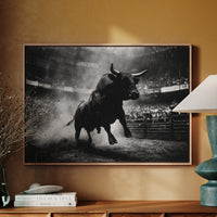 Framed black and white bull artwork on a wall above a wooden cabinet with decorative items.