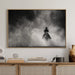 Wooden cabinet with decorative items and a framed black and white artwork on a wall.
